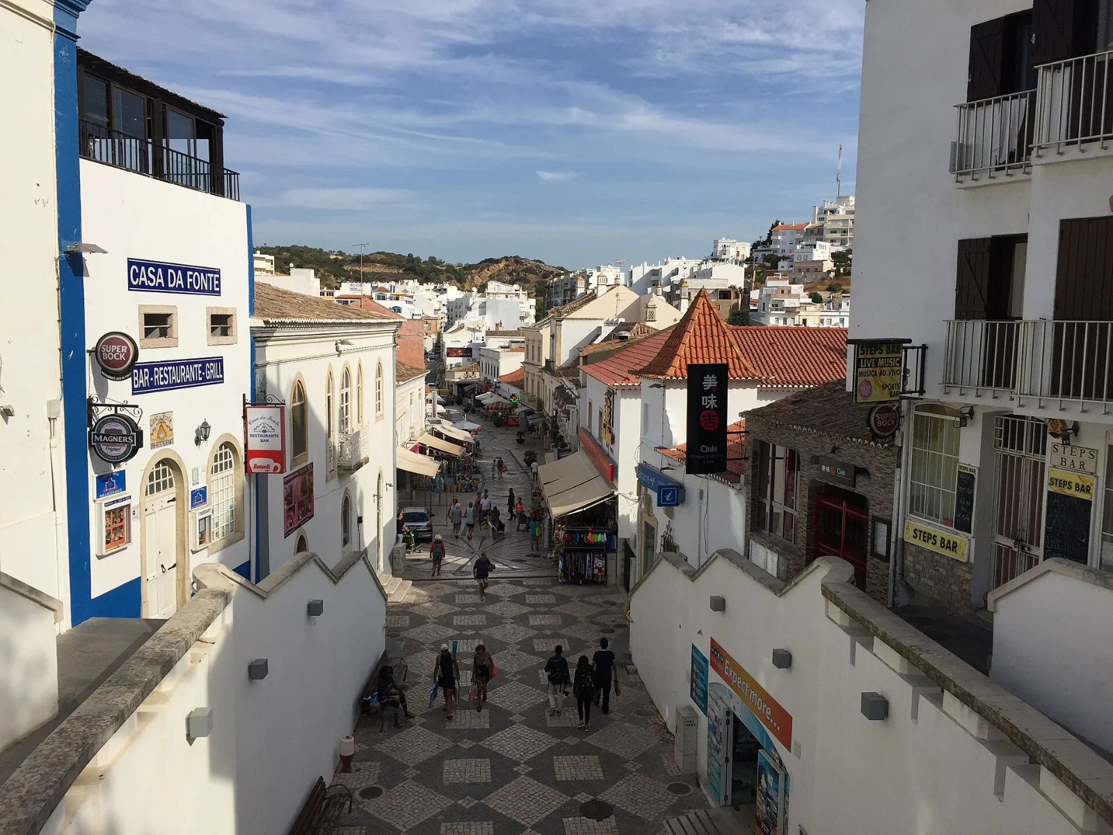 Lively street with white houses in Albufeira Old Town