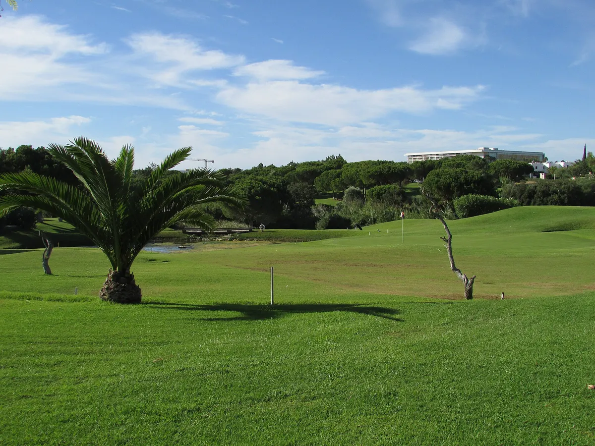 Fairway of the Balaia golf course framed by pine trees