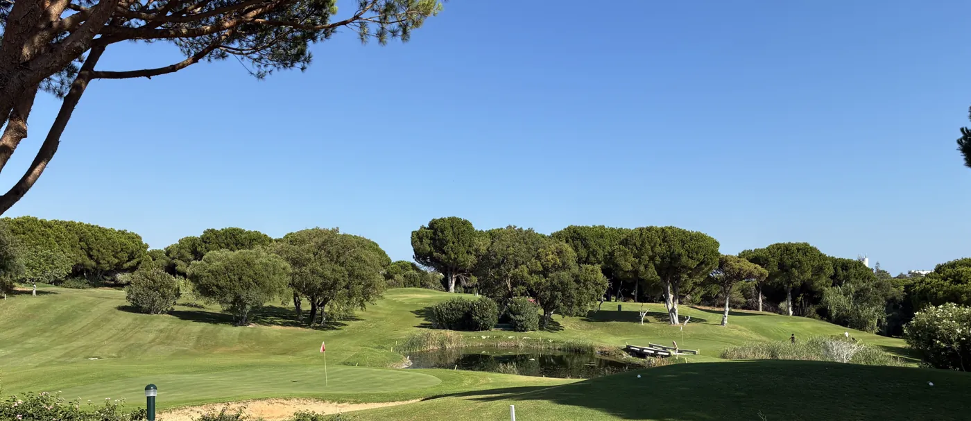 Fairway of the Balaia golf course framed by pine trees